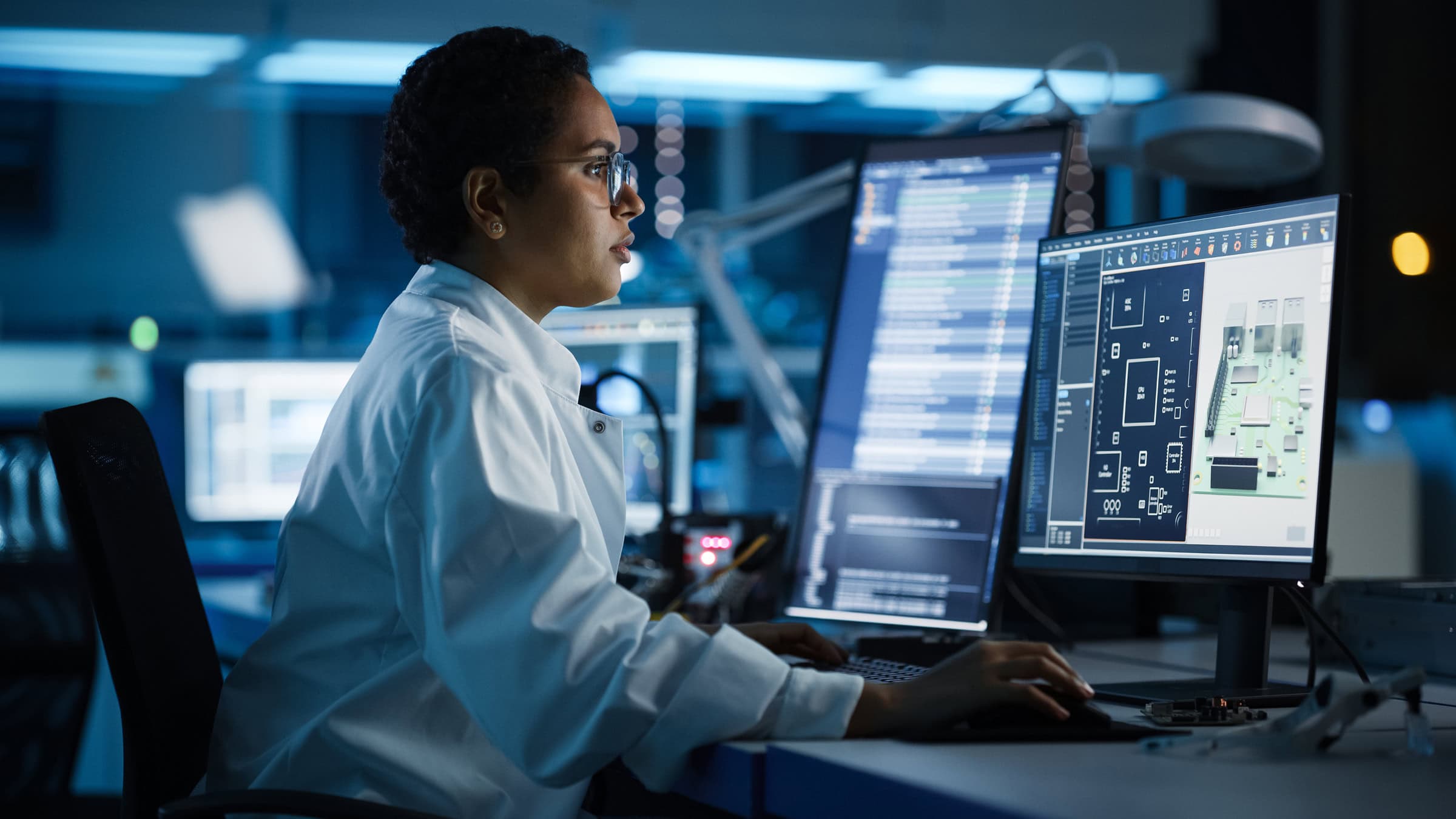 Engineer working on a computer in low lighting.