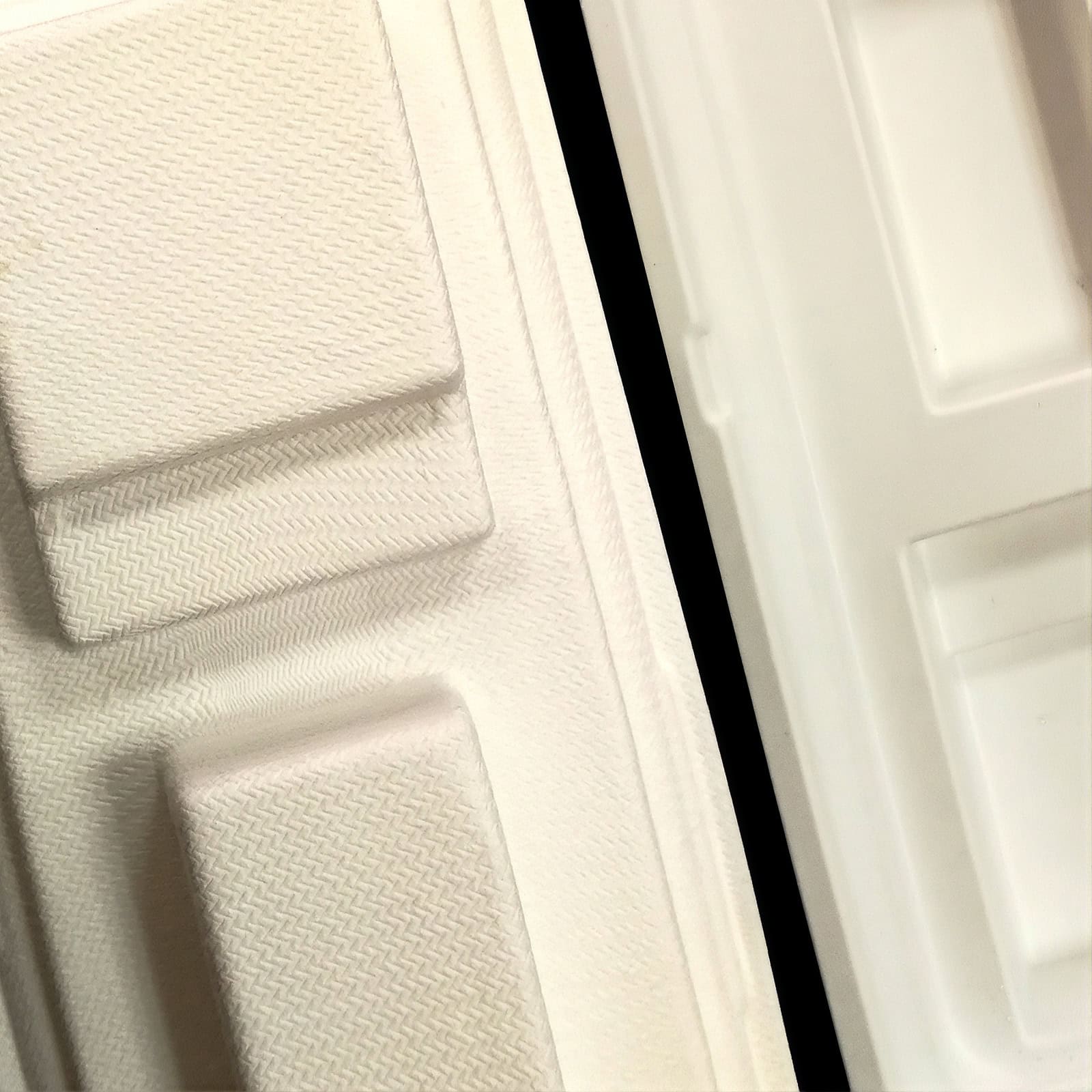 Close up of molded fiber packaging. Resembles the quality and shape available in plastic materials, but is made entirely of fiber materials.
