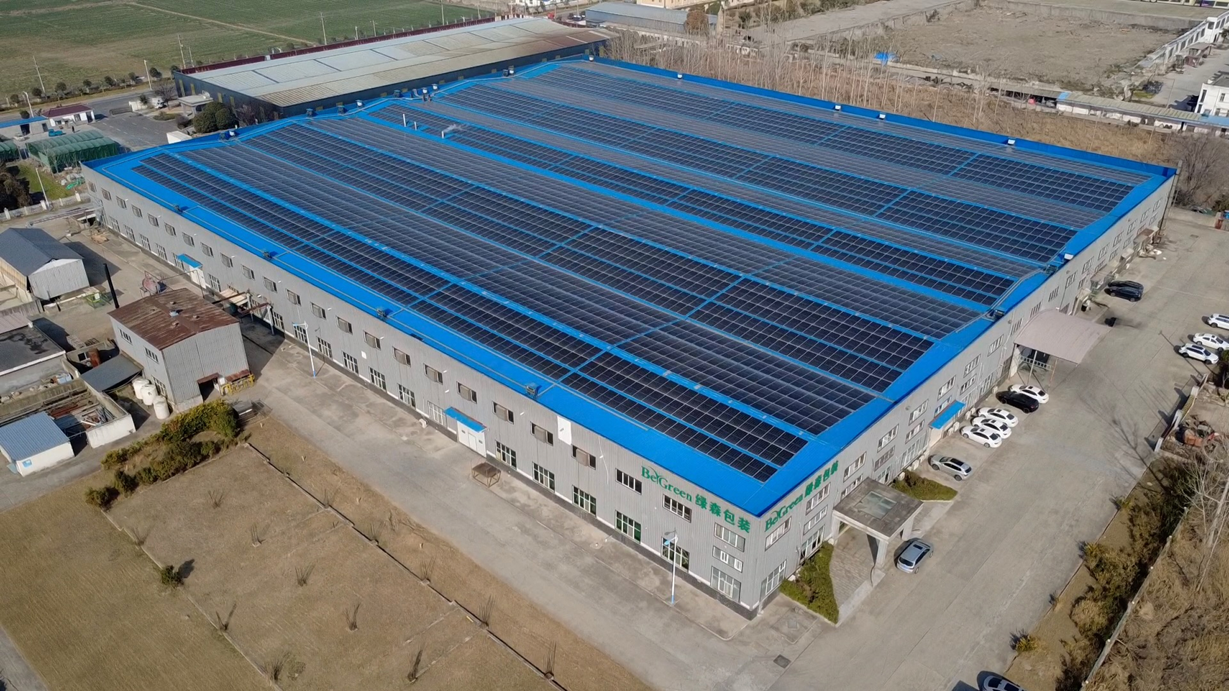 Aerial shot of BeGreen facilities featuring solar panels on roof.