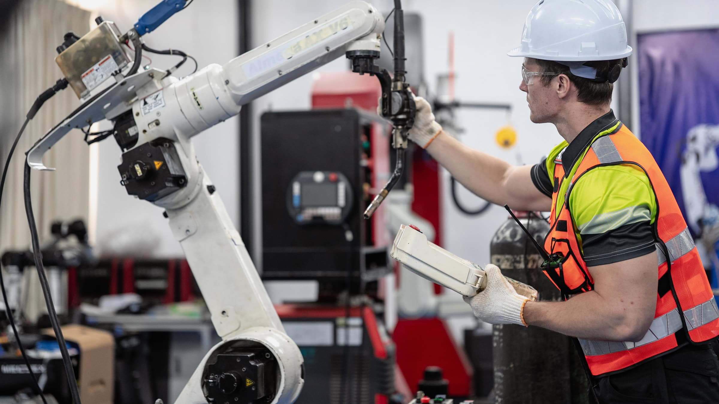 Worker conducts diagnostics on machinery in a manufacturing facility