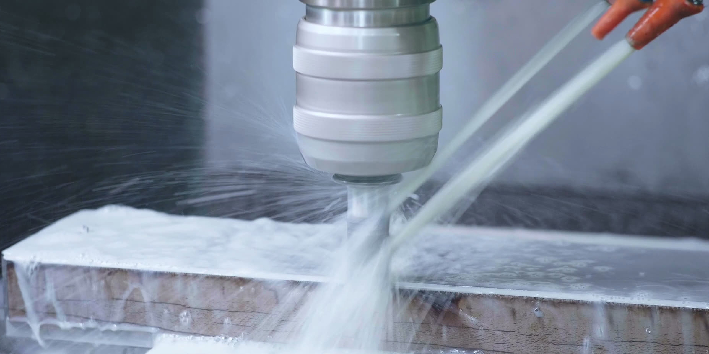 CNC machine cuts metal pieces to create new tools, leaving debris behind.