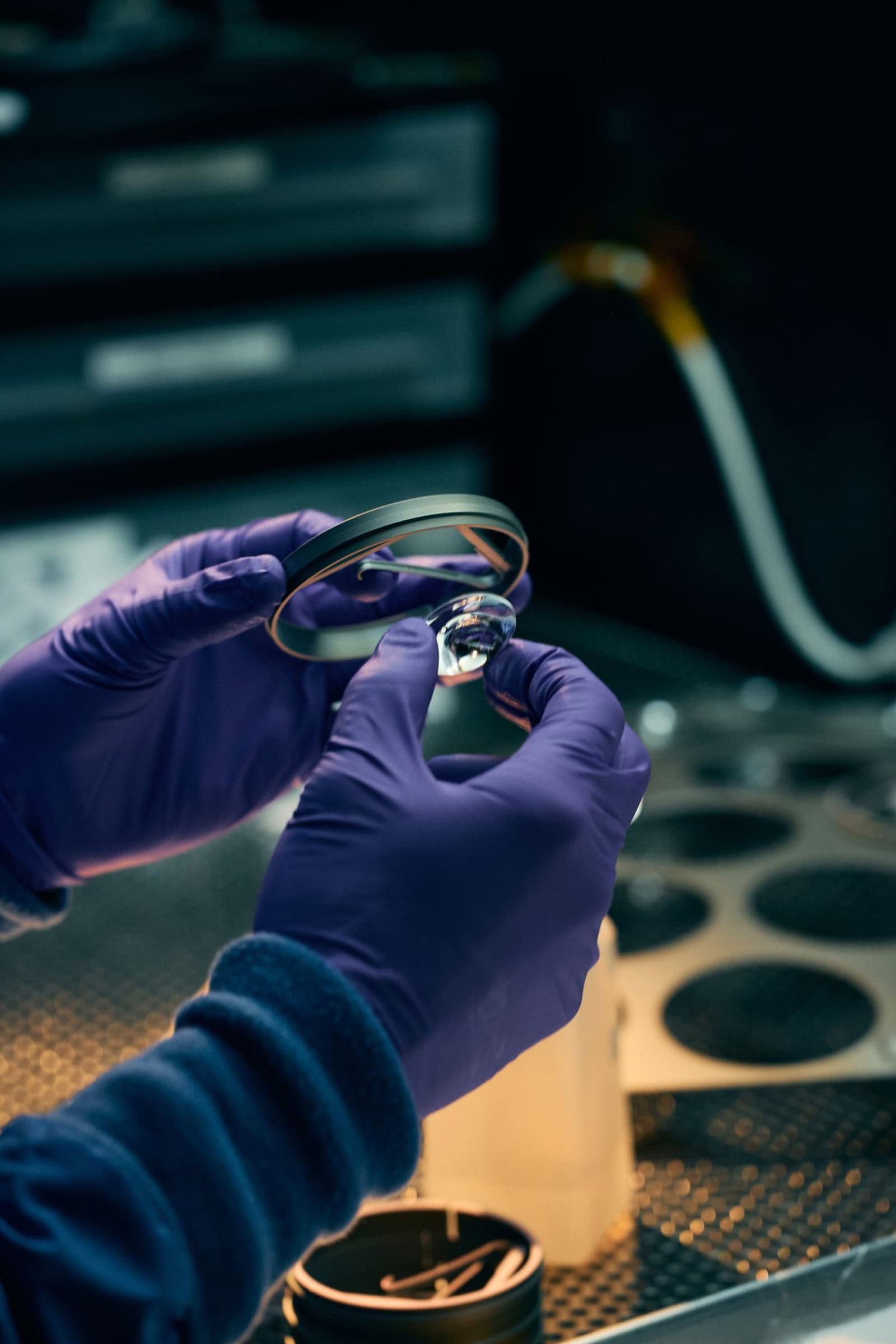 Worker inspects components that have been removed from a machine mold.